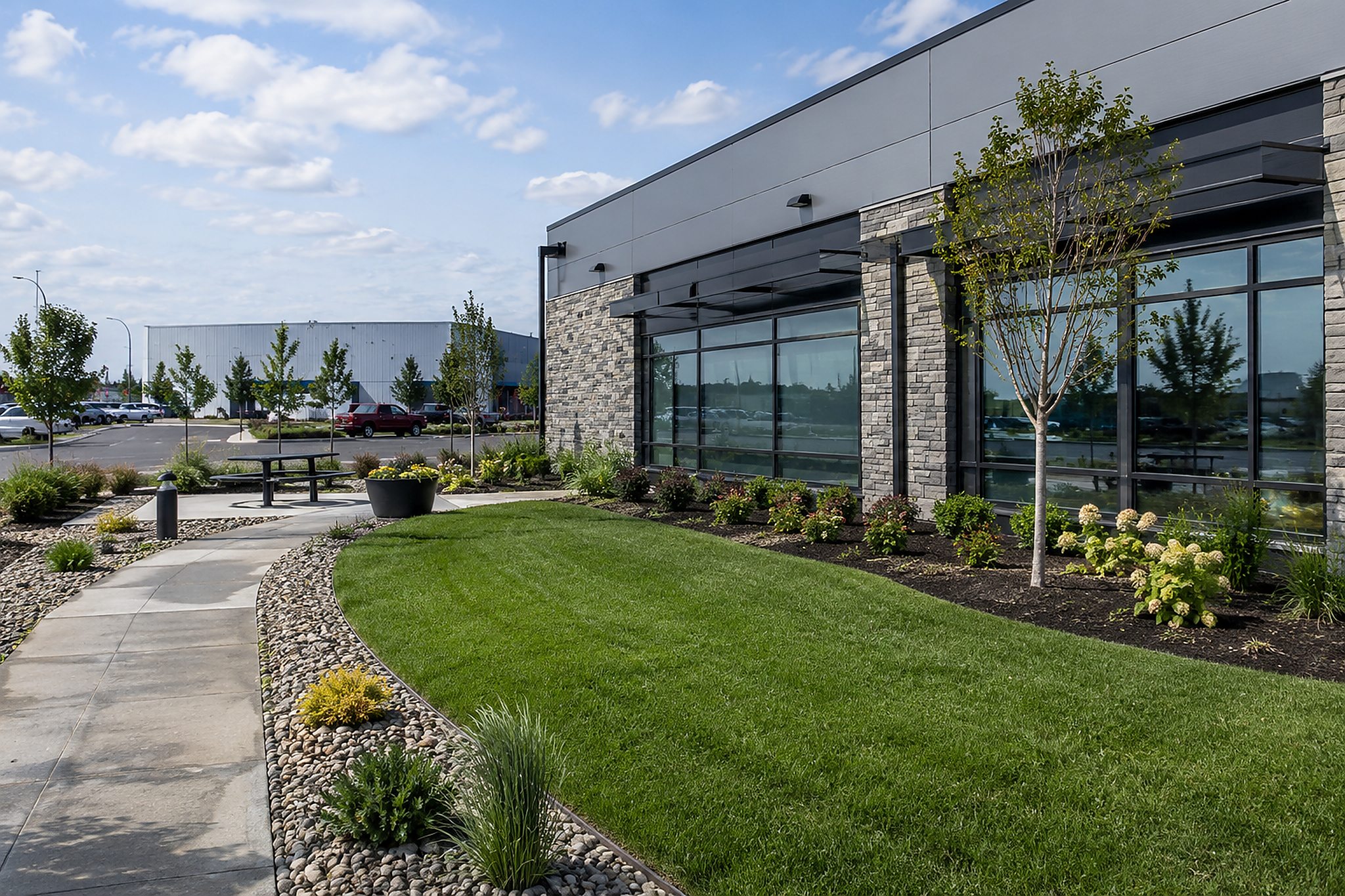 Commercial building with finished grass, planting beds, and site landscaping